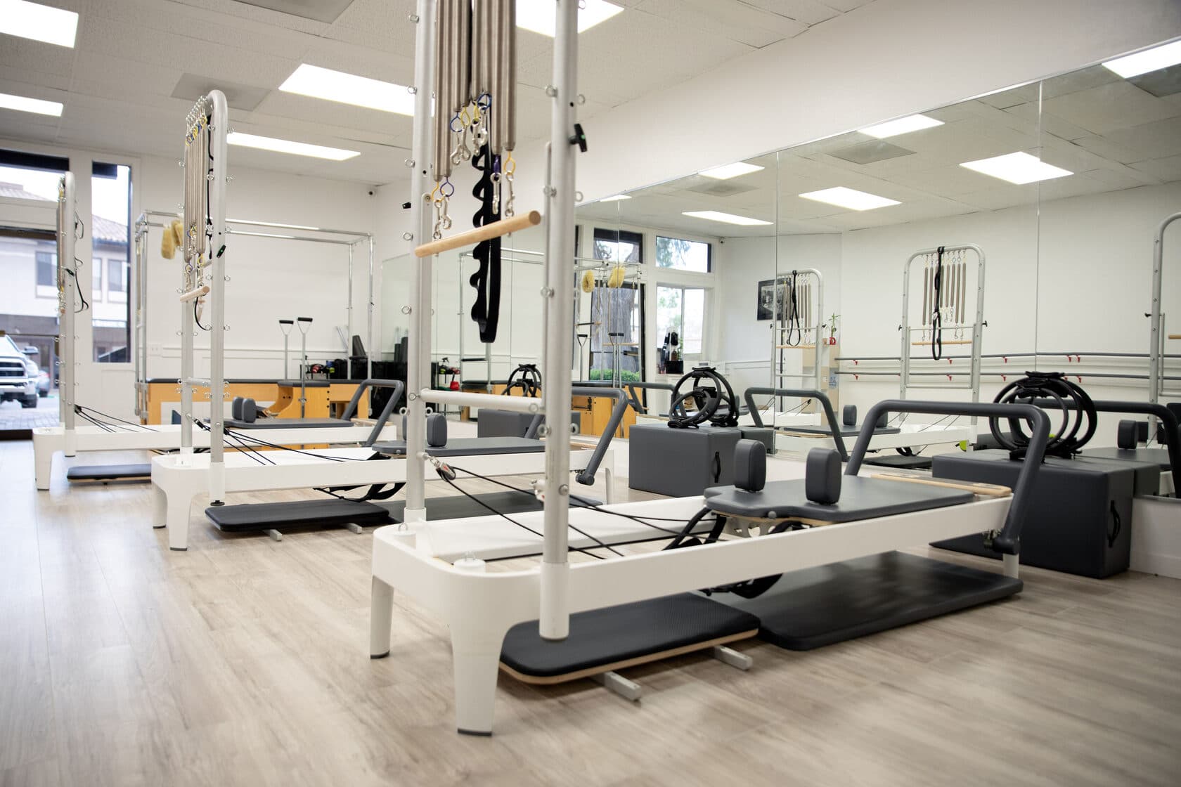 Row of Pilates reformers with tower attachments